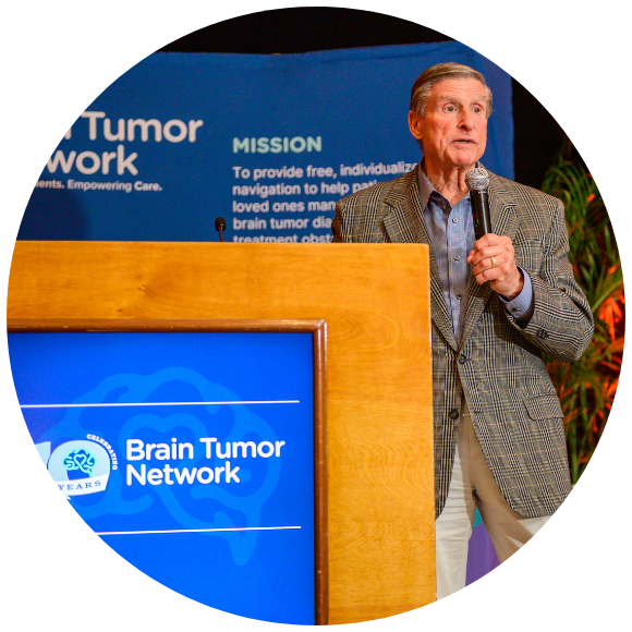 Rick Sontag speaks at a podium at the 10 year celebration for BTN