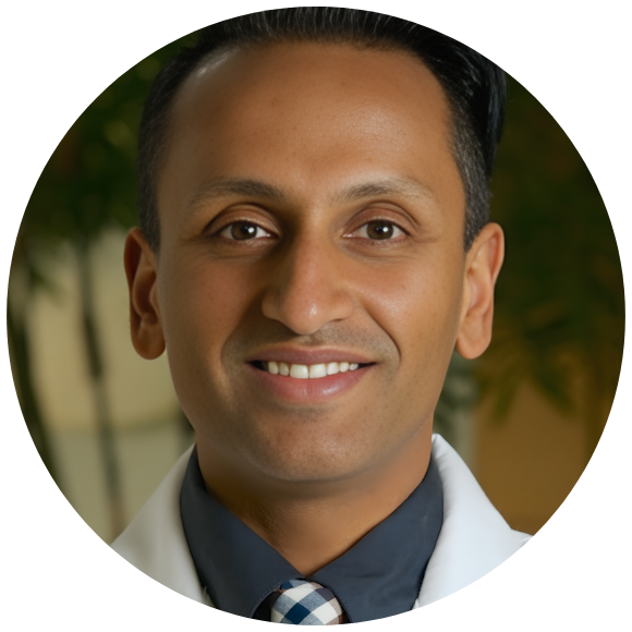 Healthcare professional in a white coat smiling in a clinical setting.