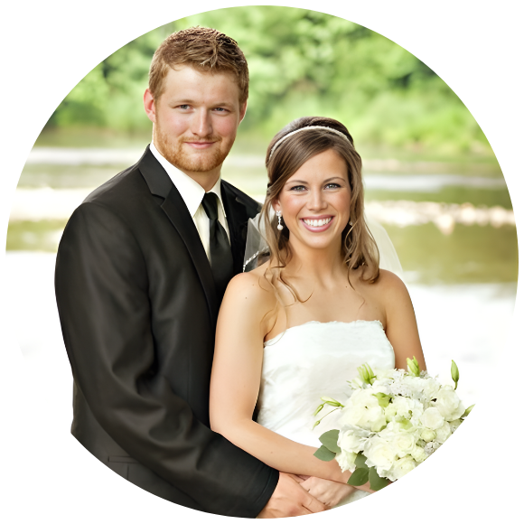 Bride and groom smiling together on their wedding day outdoors.