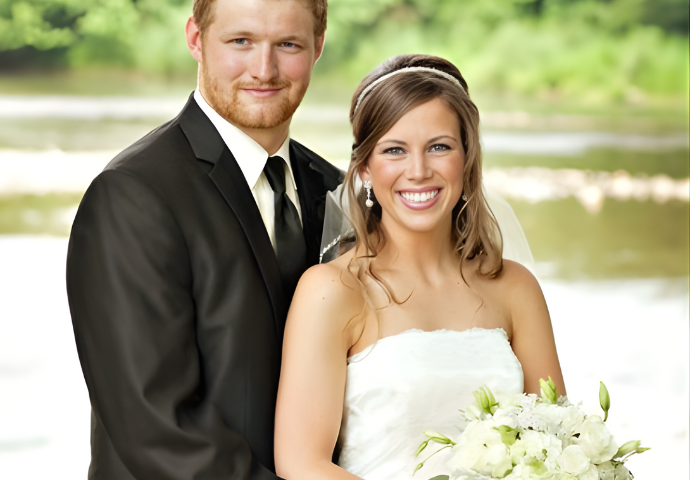 Bride and groom smiling together on their wedding day outdoors.