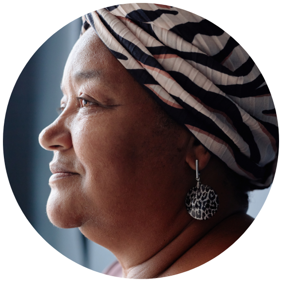 Woman wearing a headscarf in a calm side-profile portrait.