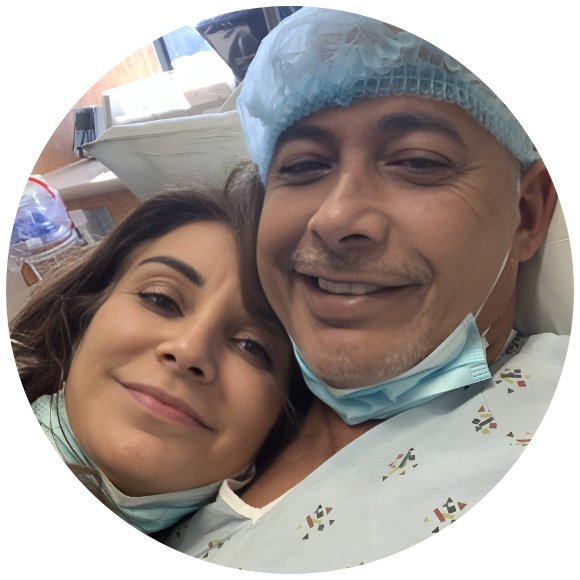 Patient in a hospital bed smiling with a loved one before a medical procedure.