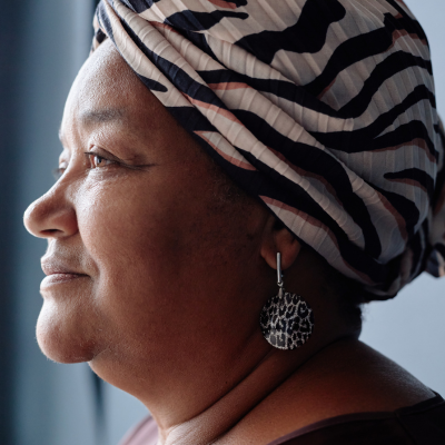 Woman wearing a headscarf in a calm side-profile portrait.