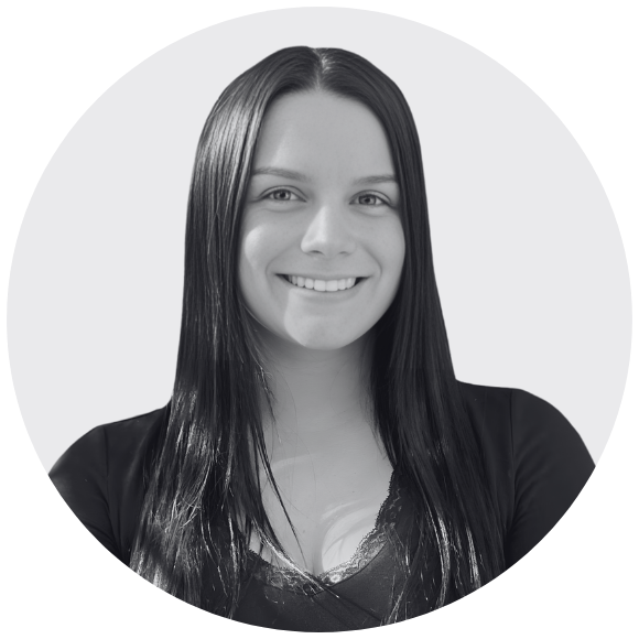 a headshot of a young female professional smiling at the camera with long dark hair