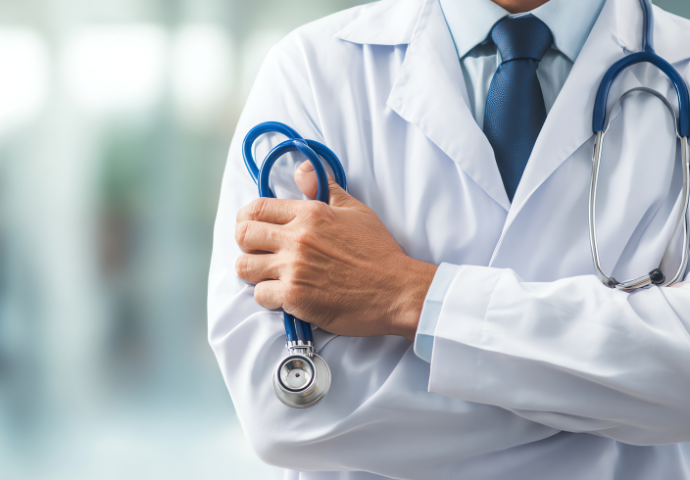 close-up of a doctor with arms crossed holding a stethoscope