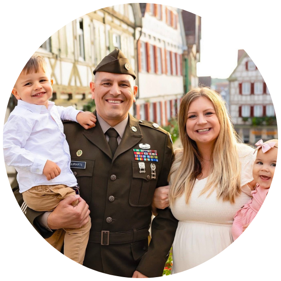 A military man poses with his wife and two young children