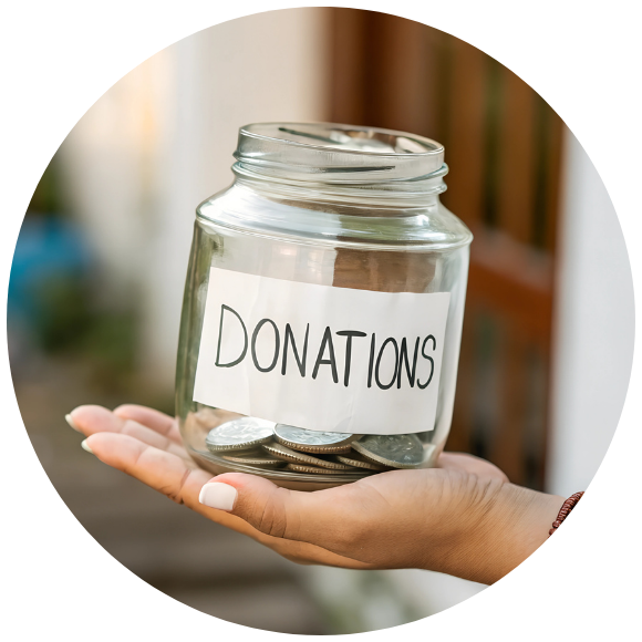 a hand holding a donation jar